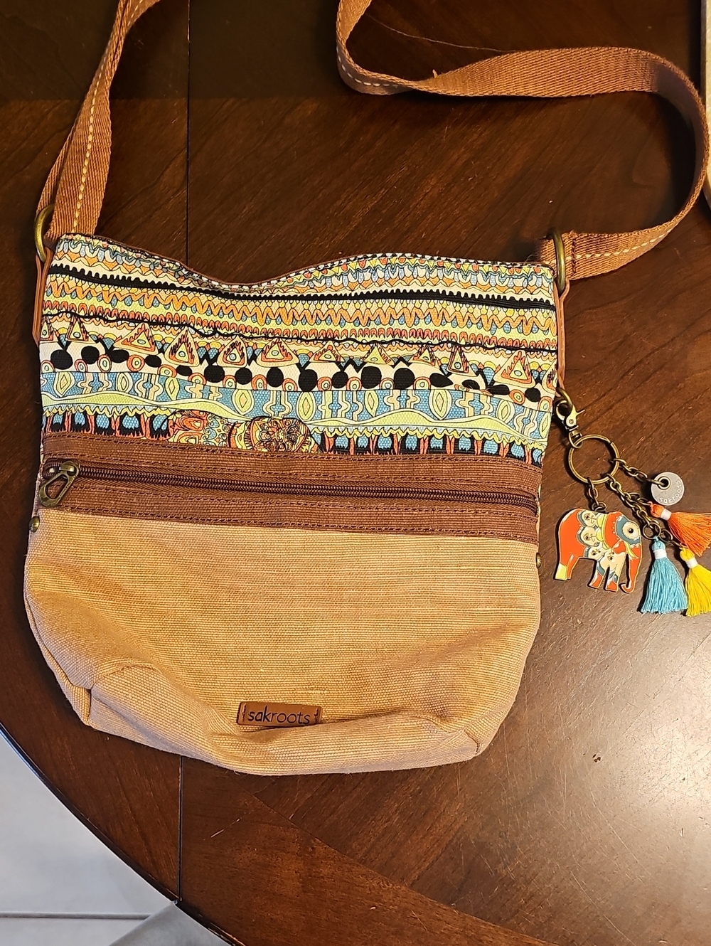 Sakroots Tan and Multicolor Patterned Crossbody with Elephant Tassel Charm